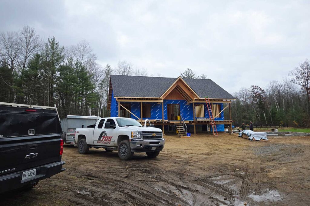 Professional roofing contractor installing shingles