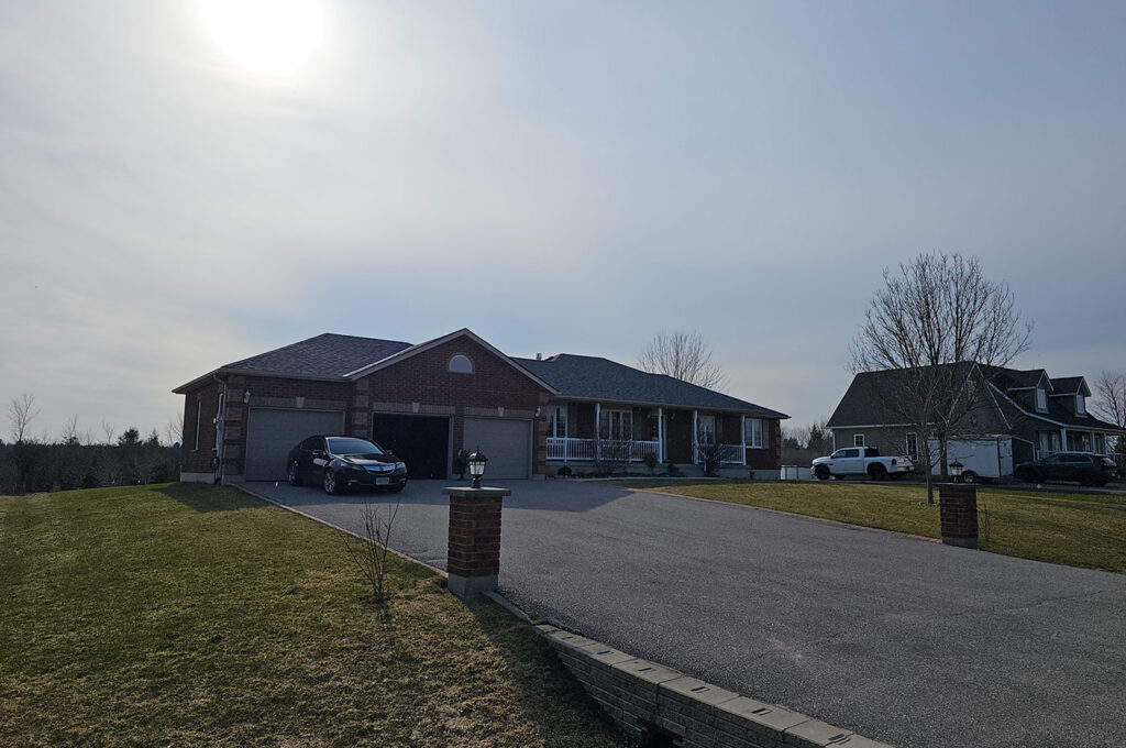 Roofing contractor inspecting residential roof