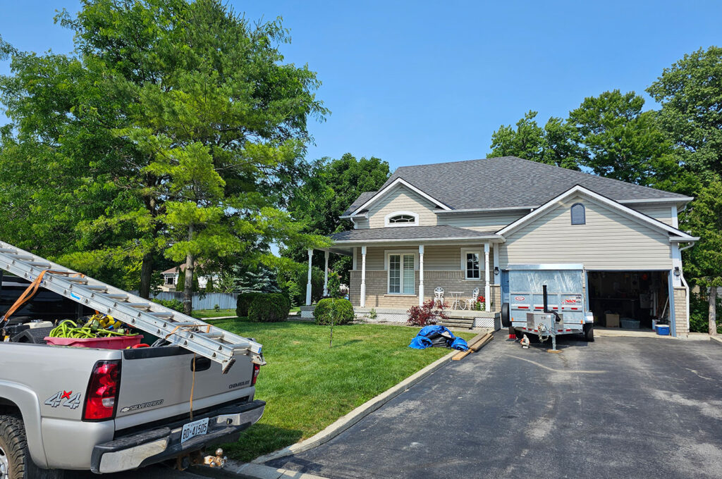 Roofing team installing asphalt shingles on home